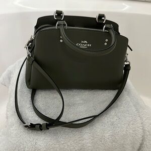 Coach green crossbody bag with detachable strap.  Measures 10” W x 6” H x 5” D.